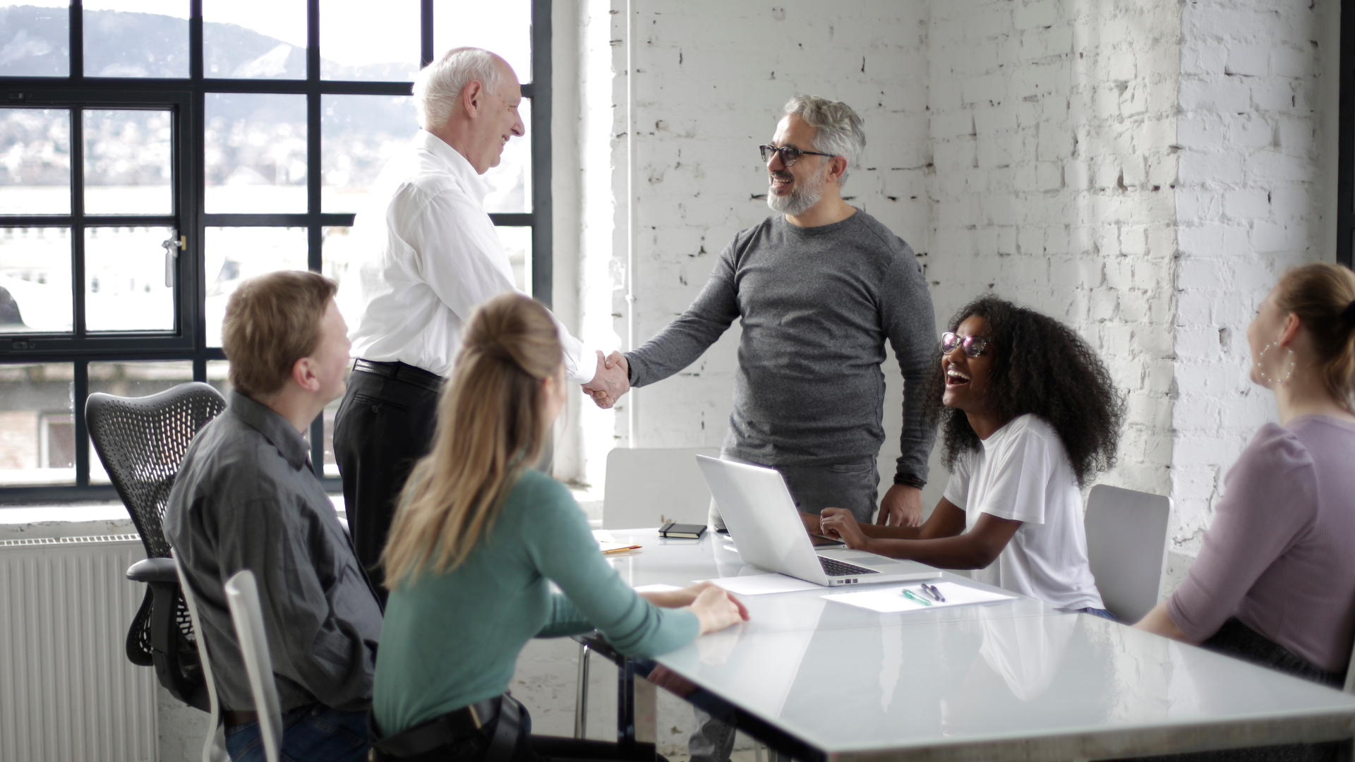 Two people shake hands