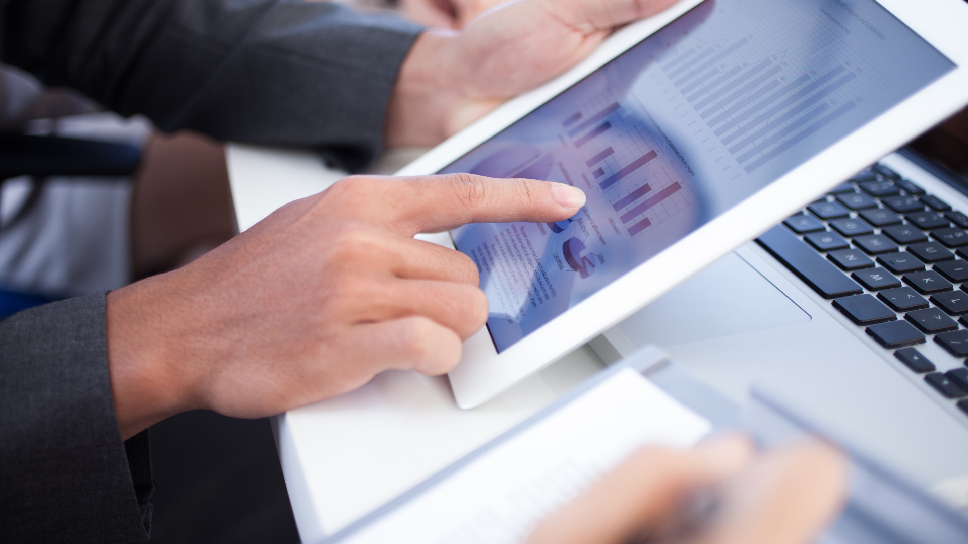 Individual looking at a report on a tablet