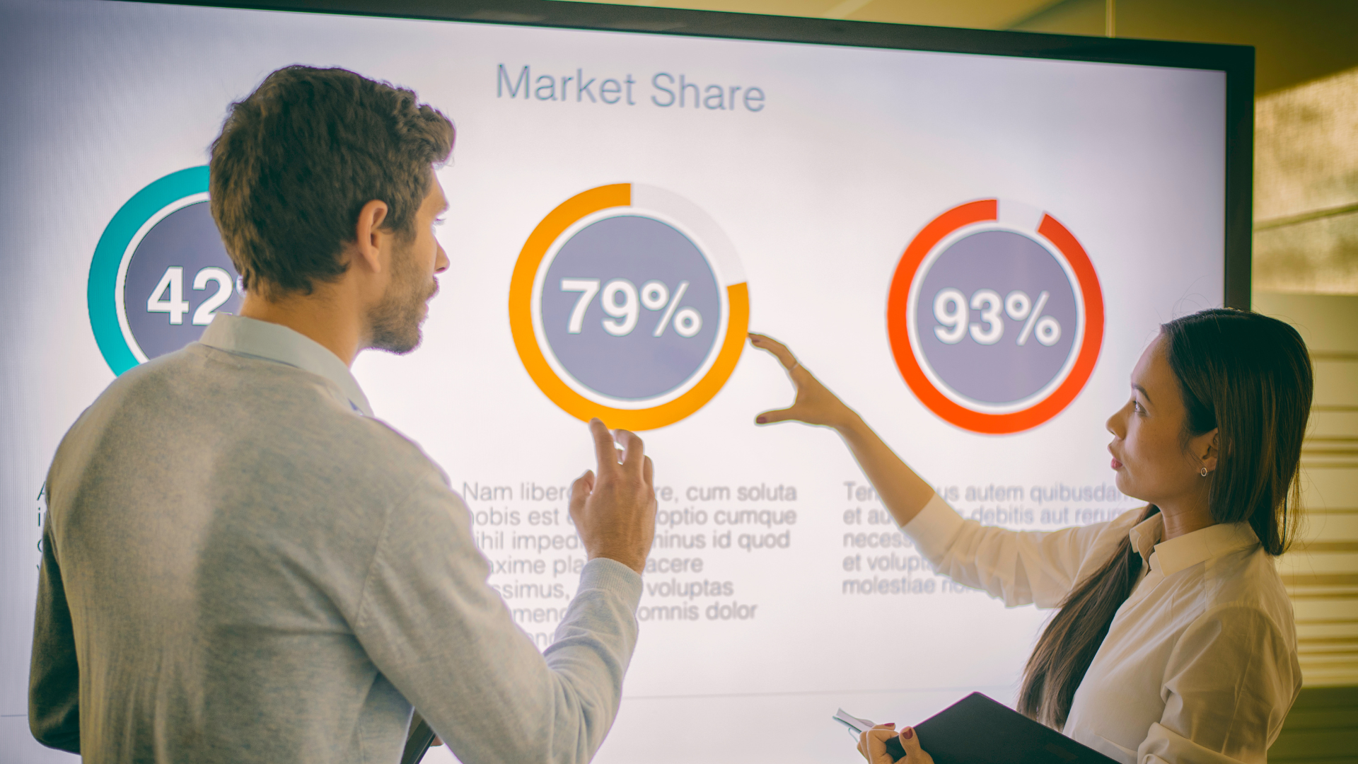 Two people looking at a market share report